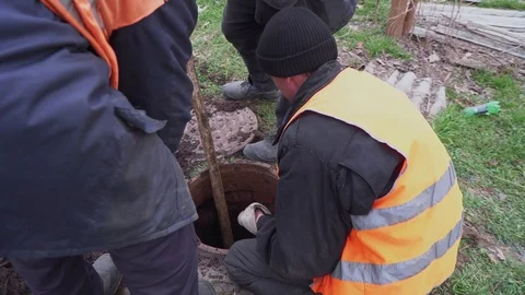 Workers clean manhole and take out dirt closeup Stock Footage 103350208