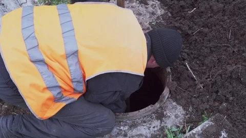 Workers clean manhole and take out dirt and debris Stock Footage 103350256