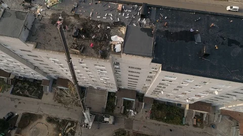 Workers clean the roof of a multi-storey building from an old roofing felt. Stock Footage 123200709