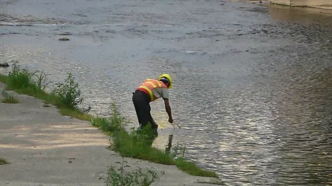 Workers clean up rubbish in the river Stock Footage 118102372