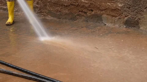 Workers clean the streets after the flood Stock Footage 294085659