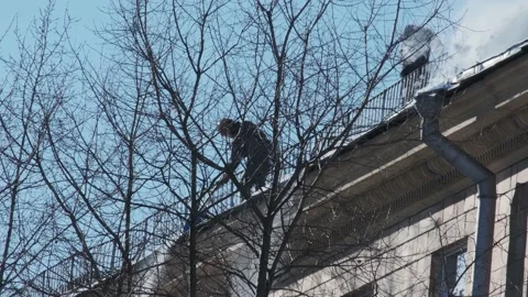 Workers cleaning and dumping snow and ice from roofs in the city. Winter city Video stock 154356576