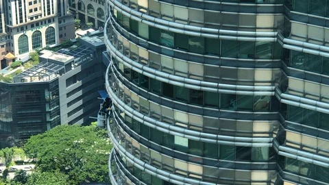 Workers cleaning glass windows of Petronas twin tower, Kuala Lumpur Stock Footage 123679999