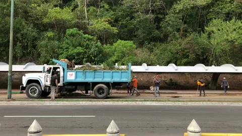 Workers cleaning main roads during the recovery of the Central University in Stock Footage 167867592