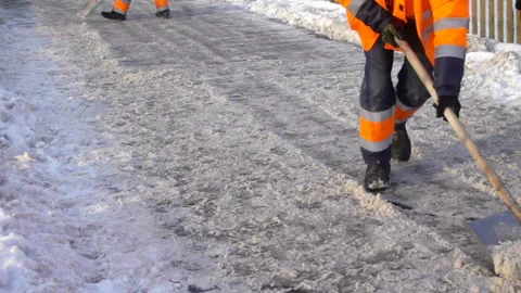 Workers cleaning the road from snow in slow motion Stock Footage 146749703