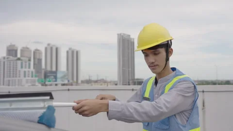 Workers cleaning solar panels on the top floor of the building. Stock Footage 244022399