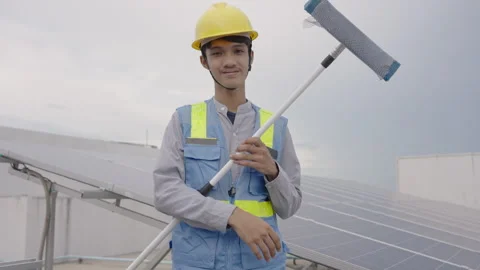 Workers cleaning solar panels on the top floor of the building. Video stock 244022417