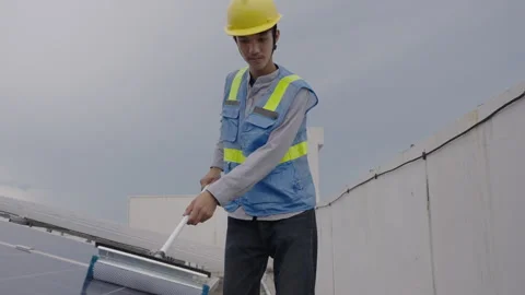 Workers cleaning solar panels on the top floor of the building. Video stock 244022493