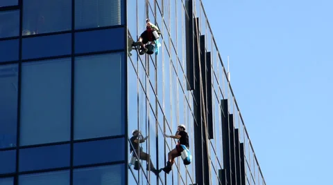 Workers cleaning windows on office skyscraper Stock Footage 56242040