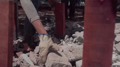 Workers clearing rubble at a demolition site in slow motion Stock Footage 345334656