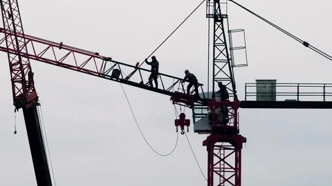 Workers Climb Onto Big Crane at Construction Site Video stock 275239397