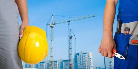 Workers Closeup of workers with instruments on building background Copyrig... Fotos de archivo