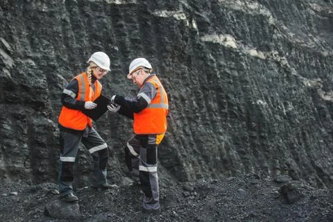 Workers with coal at open pit Stock Photos
