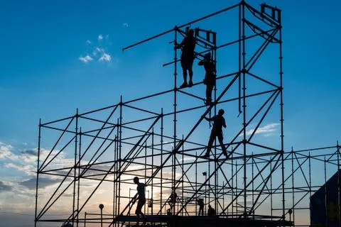 Workers collect a scene in the light of the sunset sun. Vertical  arrangement Stock Photos