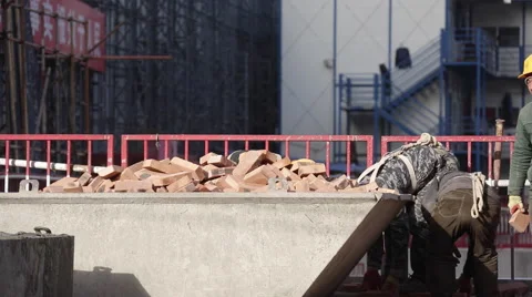Workers collecting bricks at a construction site in Beijing Stock Footage 44836925