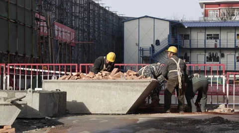 Workers collecting bricks at a construction site in Beijing Stock Footage 44836977