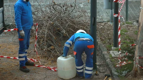 Workers of a company fasten a light pole to the ground with concrete Stock Footage 147336424