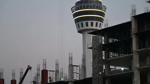 Workers construct concrete floors beside Samut Prakan tower Stock Footage 339875503