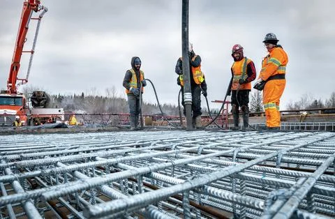Workers constructing a concrete slab for a bridge 스톡 사진