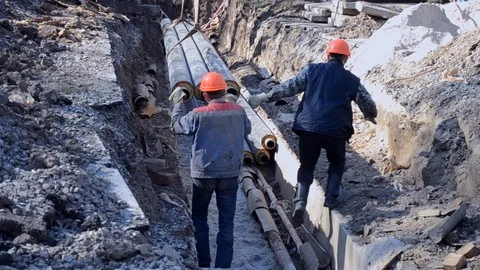 Workers with construction crane put new water pipes with concrete slabs Stock Footage 106802032