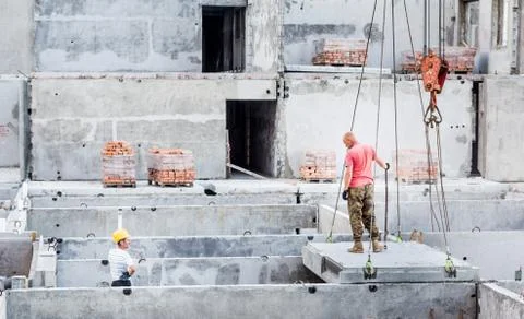 Workers on the construction of high-rise building. Multi-storey construction. Stock Photos