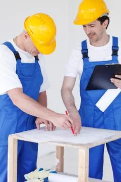 Workers with construction plan Stock Photos