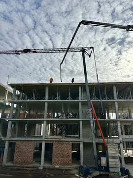 Workers at a construction site against the backdrop of the construction of .. Stock Photos