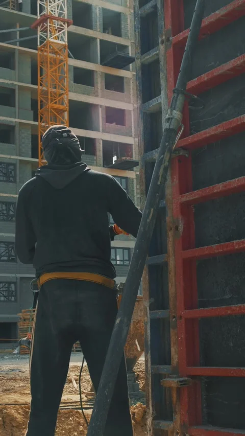 Workers at construction site are erecting formwork and pouring concrete Stock Footage 346703514