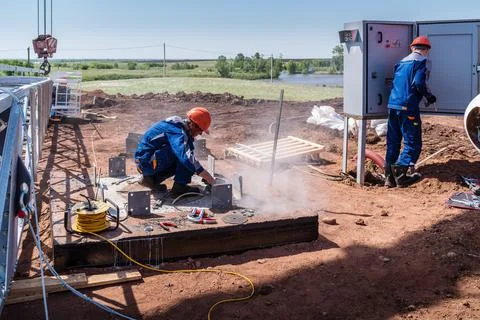 Workers at construction site are preparing for installation of a wind turbine Stock Photos