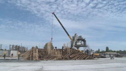Workers at the construction site. Construction of a reinforced concrete building Stock Footage 104195244