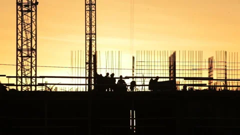 Workers at the construction site during sunset building a house Video stock 88503504