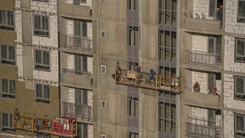 Workers at the construction site make the facade Stock Footage 172429222