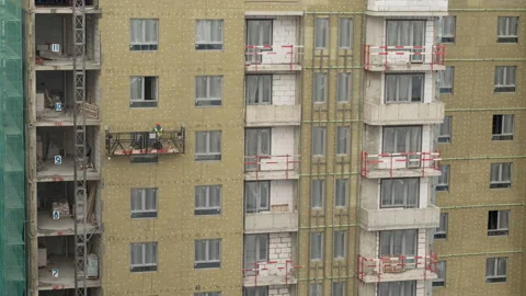 Workers at the construction site make the facade Stock Footage 172472472