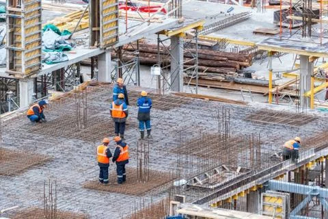 Workers at a construction site. Stock Photos