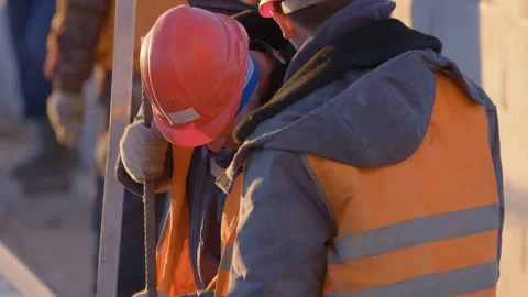 Workers at a construction site use metal fittings to clear ventilation ducts  Stock Footage 147633514