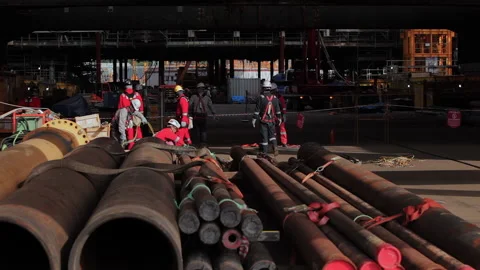 Workers at the construction site work with pipes Stock Footage 231214999