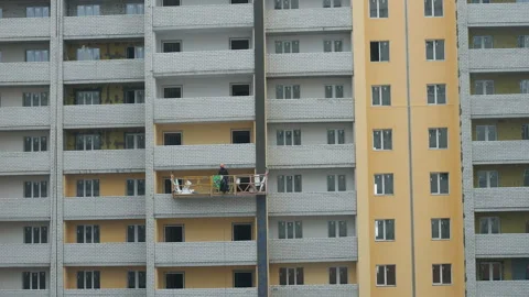 Workers at the construction site work in a suspended cradleю. Russia, Saratov - Stock Footage 123892286