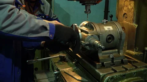 Workers control and work on a lathe. Video stock 145867491