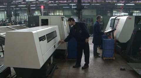 Workers control cnc machine, typing on monitor, set the function. metal industry Stock Footage 49029789