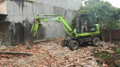 Workers control heavy excavator construction  house Stock Photos