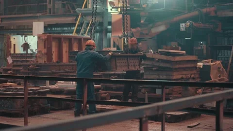 Workers control moving mold for metal casting in foundry, heavy metallurgical Stock Footage 155711712