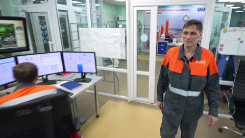 Workers at the control panel in production. Stockbeeldmateriaal 294972606