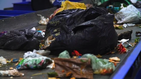 Workers at conveyor sorting garbage at a recycling plant. 4K (UHD) Stock Footage 112259785