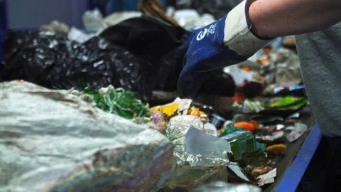 Workers at conveyor sorting garbage at a recycling plant. Stock Footage 112420780