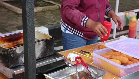 Workers cook sausages for clients Stock Footage 216409875