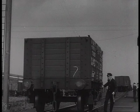 Workers counting train trucks and writing numbers with chalk, UK, 1941 Stock Footage 142215426
