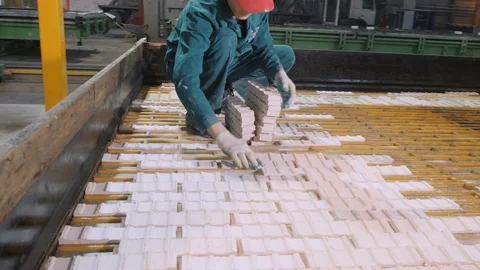 Workers cover concrete construction panel with white bricks Stock Footage 124893035