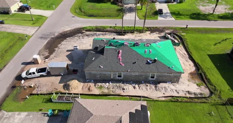 Workers covering private house with asphalt shingles. Rooftop installation Stock Footage 346261831