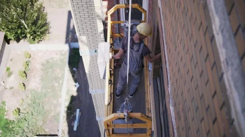 Workers on the cradle of the construction Stock Footage 159954308