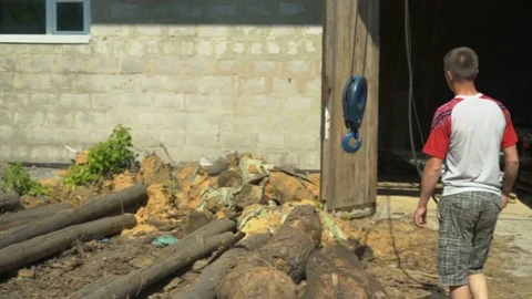 Workers With a Crane Move The Beam in The Shop With the Sawmill Stock Footage 76641300